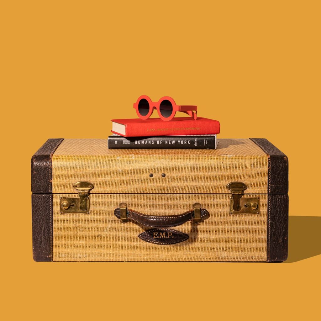 brown and black suitcase with red and yellow plastic toy