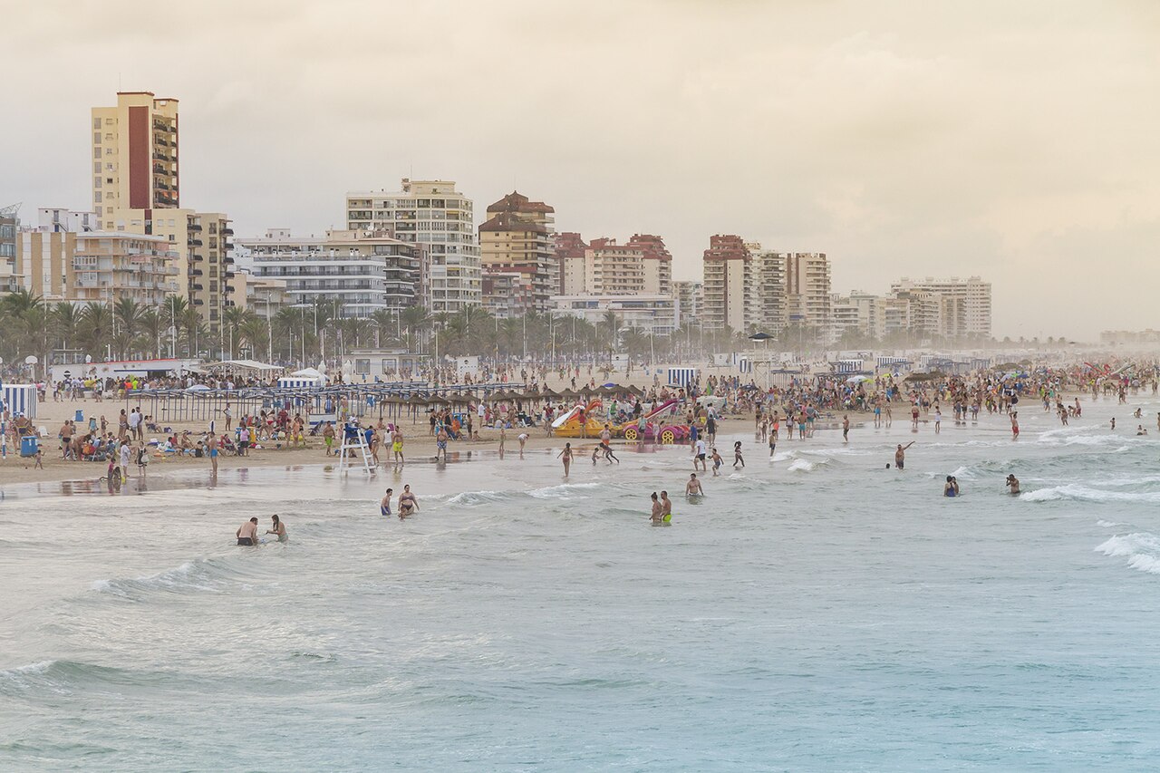 Playa de Gandia con su paseo marítimo y bañistas, costa de Valencia