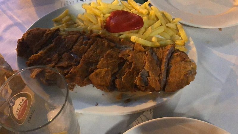 Cachopo asturiano con patatas fritas servido en una sidrería de Asturias
