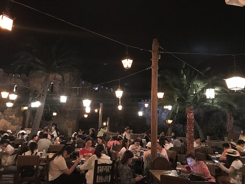 Terraza nocturna del restaurante Barbossa's Bounty junto a Piratas del Caribe en Disneyland Shanghai